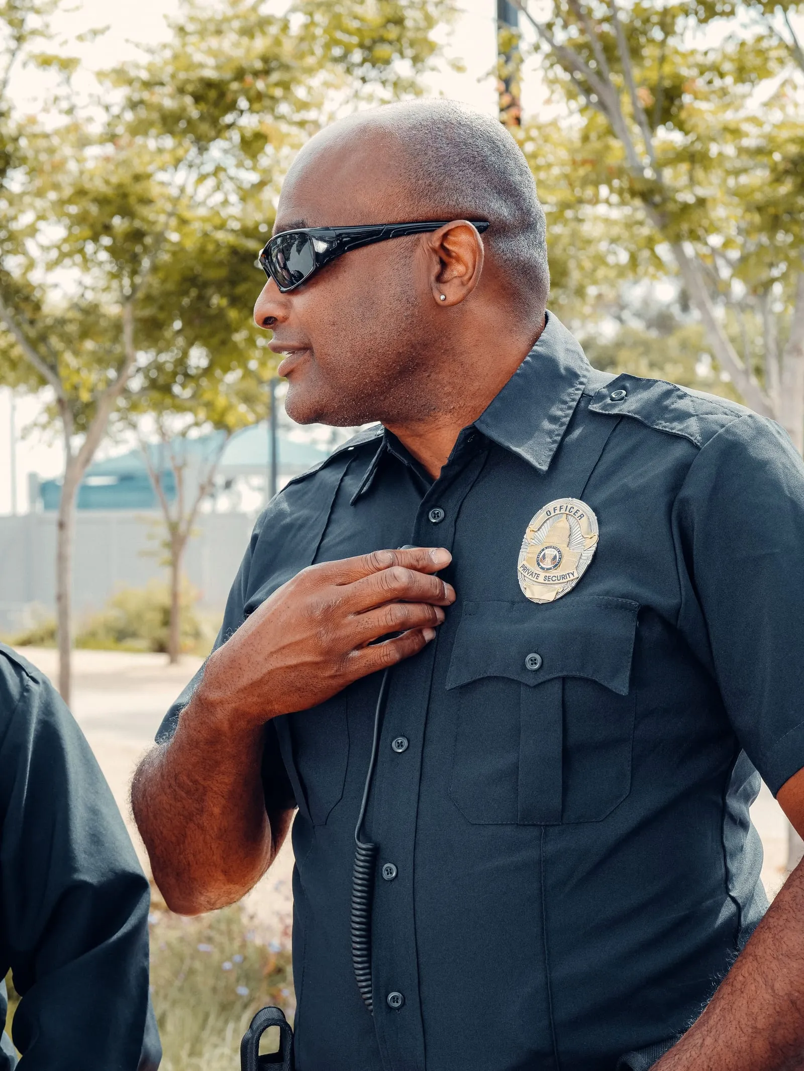 A uniformed private security officer on patrol outside a storage facility.